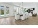 Dining area with an elegant wood table, and seating for eight, with views of the backyard at 2797 Turtle Head Peak Dr, Las Vegas, NV 89135