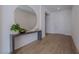 Bright entryway featuring modern console table with round mirror and elegant decor at 2797 Turtle Head Peak Dr, Las Vegas, NV 89135