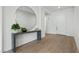 Elegant foyer with modern console table, round mirror, and wood flooring at 2797 Turtle Head Peak Dr, Las Vegas, NV 89135