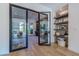 Bright foyer with modern glass doors, wood floors, and stylish built-in shelving at 2797 Turtle Head Peak Dr, Las Vegas, NV 89135
