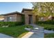 Charming single-story home with stone accents, manicured lawn, and mature landscaping creating a welcoming curb appeal at 2797 Turtle Head Peak Dr, Las Vegas, NV 89135