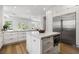 Bright, modern kitchen with center island, stainless refrigerator, and plenty of cabinet space at 2797 Turtle Head Peak Dr, Las Vegas, NV 89135