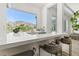 Kitchen bar with counter seating, modern countertops, and scenic mountain views through the window at 2797 Turtle Head Peak Dr, Las Vegas, NV 89135