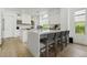 Bright kitchen with a large island, white cabinetry, and bar stool seating at 2797 Turtle Head Peak Dr, Las Vegas, NV 89135