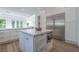 Bright, open kitchen with a large island, stainless steel fridge, and modern appliances for a chef's delight at 2797 Turtle Head Peak Dr, Las Vegas, NV 89135