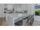 Open-concept kitchen with marble countertops, stainless steel appliances, and bar seating at 2797 Turtle Head Peak Dr, Las Vegas, NV 89135