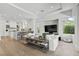 Open concept living area featuring hardwood floors, modern kitchen view, and stylish decor at 2797 Turtle Head Peak Dr, Las Vegas, NV 89135