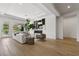 Bright living room with modern fireplace, wood floors, and access to outdoor space at 2797 Turtle Head Peak Dr, Las Vegas, NV 89135