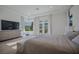 Bright primary bedroom featuring tray ceilings, balcony access, and stylish decor at 2797 Turtle Head Peak Dr, Las Vegas, NV 89135