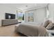 Bright bedroom featuring an upholstered bed, a bench and mountain views at 2797 Turtle Head Peak Dr, Las Vegas, NV 89135
