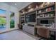 Spacious home office with built-in shelving, dual workstations, and access to the outdoor area at 2797 Turtle Head Peak Dr, Las Vegas, NV 89135