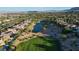 Stunning aerial view of a luxury golf course community with a lake and mountain views at 2837 Turtle Head Peak Dr, Las Vegas, NV 89135