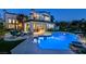 Backyard oasis boasts a pool, jacuzzi, outdoor seating, and beautiful landscaping for ultimate relaxation and entertainment at 2837 Turtle Head Peak Dr, Las Vegas, NV 89135