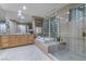 Bright bathroom with a glass shower and a soaking tub with tile surround at 2837 Turtle Head Peak Dr, Las Vegas, NV 89135