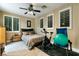 Bedroom with neutral walls, carpet and ceiling fan, with a bed and exercise equipment at 2837 Turtle Head Peak Dr, Las Vegas, NV 89135