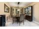 Elegant dining room with modern lighting, seating for eight, and a glass display case at 2837 Turtle Head Peak Dr, Las Vegas, NV 89135