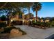 Inviting two-story home with well-maintained landscaping, a spacious driveway, and mature palm trees at 2837 Turtle Head Peak Dr, Las Vegas, NV 89135