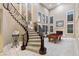Stunning curved staircase with elegant railing, high ceilings, and a fireplace create an inviting atmosphere at 2837 Turtle Head Peak Dr, Las Vegas, NV 89135