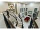 Overhead of a foyer with a pool table and elegant stairs, enhanced by a chandelier and fireplace at 2837 Turtle Head Peak Dr, Las Vegas, NV 89135