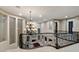 View of the foyer with a grand chandelier, dark wood railings, and elegant architectural details at 2837 Turtle Head Peak Dr, Las Vegas, NV 89135