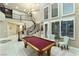 Grand foyer with a curved staircase, high ceilings, elegant chandelier, and a billiards table at 2837 Turtle Head Peak Dr, Las Vegas, NV 89135