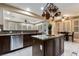 Well-lit kitchen featuring a granite countertop island, stainless steel appliances, and dark wood cabinets at 2837 Turtle Head Peak Dr, Las Vegas, NV 89135
