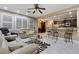 Inviting living room showcasing tile flooring, a comfortable seating arrangement, and seamless kitchen access at 2837 Turtle Head Peak Dr, Las Vegas, NV 89135