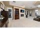 Spacious living room featuring a fireplace, built-in shelving, and plush carpeting at 2837 Turtle Head Peak Dr, Las Vegas, NV 89135