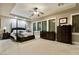 Spacious primary bedroom featuring trey ceilings, neutral carpet and a ceiling fan at 2837 Turtle Head Peak Dr, Las Vegas, NV 89135