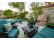 Relaxing patio area featuring plush seating with mountain views in a landscaped backyard at 2837 Turtle Head Peak Dr, Las Vegas, NV 89135