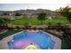 Inviting pool and spa overlook lush backyard and golf course with mountain views at 2837 Turtle Head Peak Dr, Las Vegas, NV 89135