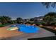 Stunning pool area with spa and lush landscaping, perfect for outdoor entertaining and relaxation at 2837 Turtle Head Peak Dr, Las Vegas, NV 89135