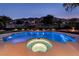 Gorgeous backyard featuring a sparkling pool, integrated hot tub, and meticulously maintained landscaping against a mountain backdrop at 2837 Turtle Head Peak Dr, Las Vegas, NV 89135
