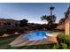 Backyard oasis with a sparkling pool, spa, and meticulously manicured landscaping at 2837 Turtle Head Peak Dr, Las Vegas, NV 89135