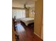 Bedroom features laminate flooring, a ceiling fan, and a large window with blinds for ample natural light at 3055 Key Largo Dr # 204, Las Vegas, NV 89120