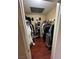 Walk-in closet featuring wood floor and storage with hanging racks for organizing clothes and shoes at 3055 Key Largo Dr # 204, Las Vegas, NV 89120