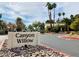 Inviting community entrance with 'Canyon Willow' sign, complemented by well-manicured landscaping and mature palm trees at 3055 Key Largo Dr # 204, Las Vegas, NV 89120