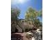 Well-maintained condo building with mature trees and sidewalks under a clear blue sky at 3055 Key Largo Dr # 204, Las Vegas, NV 89120