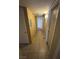 Hallway with tan-colored tile flooring and walls with access to different rooms in the home at 3055 Key Largo Dr # 204, Las Vegas, NV 89120