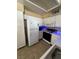 Functional kitchen featuring white cabinetry, essential appliances, and ample counter space for meal preparation at 3055 Key Largo Dr # 204, Las Vegas, NV 89120