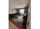 Cozy living room featuring a comfortable sectional sofa, glass coffee tables, and access to a balcony at 3055 Key Largo Dr # 204, Las Vegas, NV 89120