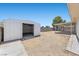Large storage shed with access door in an empty back yard with a covered patio at 321 Oil Lantern Ln, Las Vegas, NV 89145