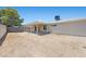 Spacious backyard featuring a covered patio, block wall fencing, and desert landscaping, perfect for outdoor living at 321 Oil Lantern Ln, Las Vegas, NV 89145