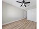 A clean bedroom with a ceiling fan, light wood floor, and a closet at 321 Oil Lantern Ln, Las Vegas, NV 89145