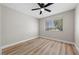 Serene bedroom with wood floors, natural light, and a ceiling fan for added comfort at 321 Oil Lantern Ln, Las Vegas, NV 89145