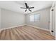 A bedroom featuring wood-look floors, white trim, and a ceiling fan at 321 Oil Lantern Ln, Las Vegas, NV 89145
