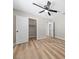 Bedroom with a ceiling fan, wood flooring, and an open closet at 321 Oil Lantern Ln, Las Vegas, NV 89145
