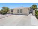 View of a single-story home with a long driveway, brick exterior, and low-maintenance front yard at 321 Oil Lantern Ln, Las Vegas, NV 89145