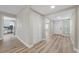 Hallway with modern flooring leads to the kitchen, living room, and front door at 321 Oil Lantern Ln, Las Vegas, NV 89145