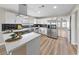Updated kitchen with stainless steel appliances, white cabinetry, and a striking black backsplash at 321 Oil Lantern Ln, Las Vegas, NV 89145